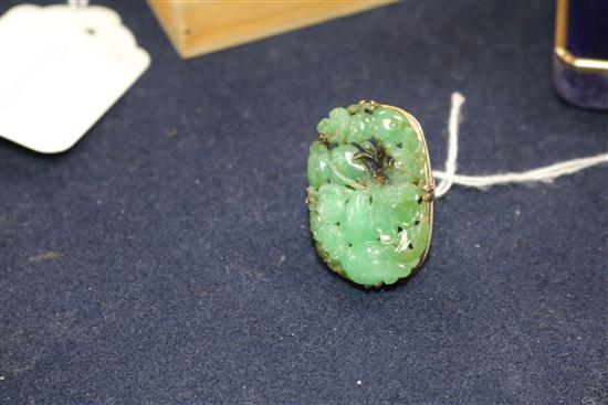 A modern jade and yellow metal-mounted bangle (unmarked) and a similar tablet ring,